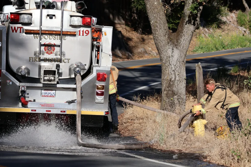 Firefighters connecting a fire truck to a hydrant in Palo Alto, California