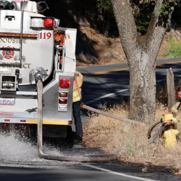 Firefighters connecting a fire truck to a hydrant in Palo Alto, California