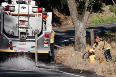 Palo Alto fire Embarcadero Firefighters connecting a fire truck to a hydrant in Palo Alto, California