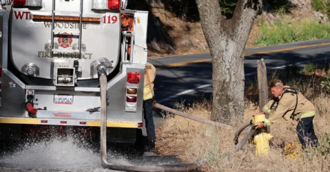 Firefighters connecting a fire truck to a hydrant in Palo Alto, California