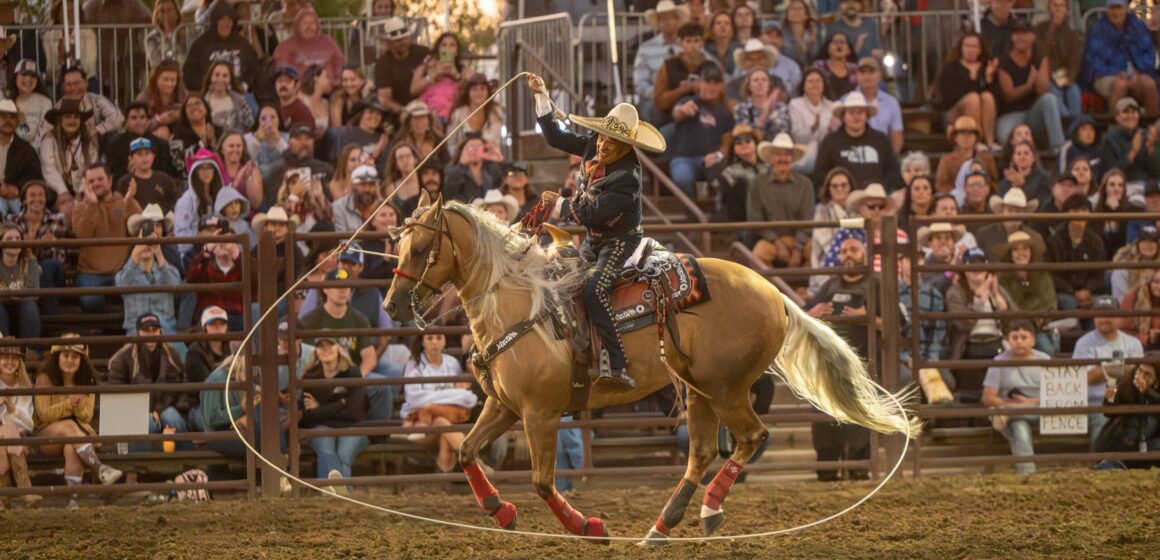 A person riding a horse swings a lasso around at a rodeo in Gilroy, California