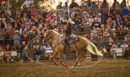 Gilroy rodeo-2 A person riding a horse swings a lasso around at a rodeo in Gilroy, California