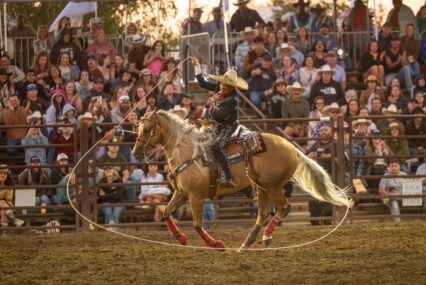 A person riding a horse swings a lasso around at a rodeo in Gilroy, California