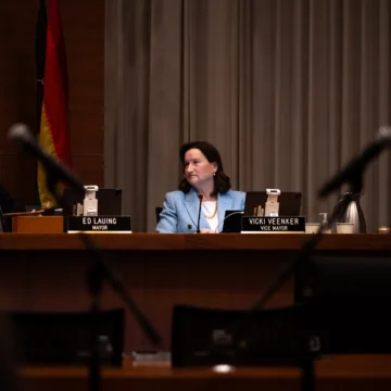 Palo Alto Vicki Veenker Embarcadero A woman sitting behind a dais at a government meeting in Palo Alto, California