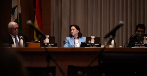 A woman sitting behind a dais at a government meeting in Palo Alto, California