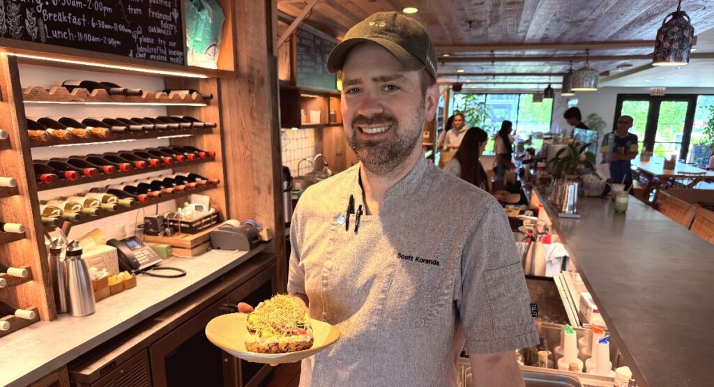 A man in a cap holds food inside a cafe in Sunnyvale, California