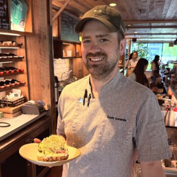 A man in a cap holds food inside a cafe in Sunnyvale, California