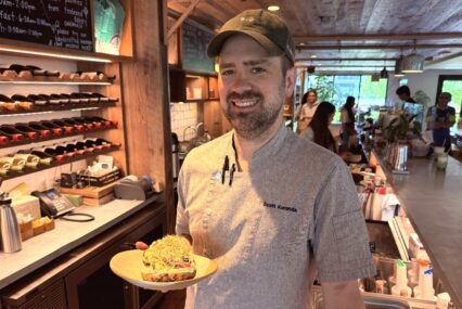 A man in a cap holds food inside a cafe in Sunnyvale, California
