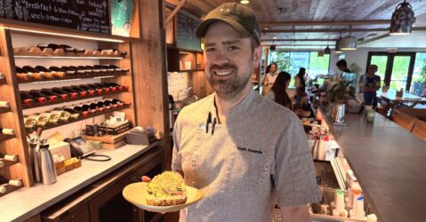 A man in a cap holds food inside a cafe in Sunnyvale, California