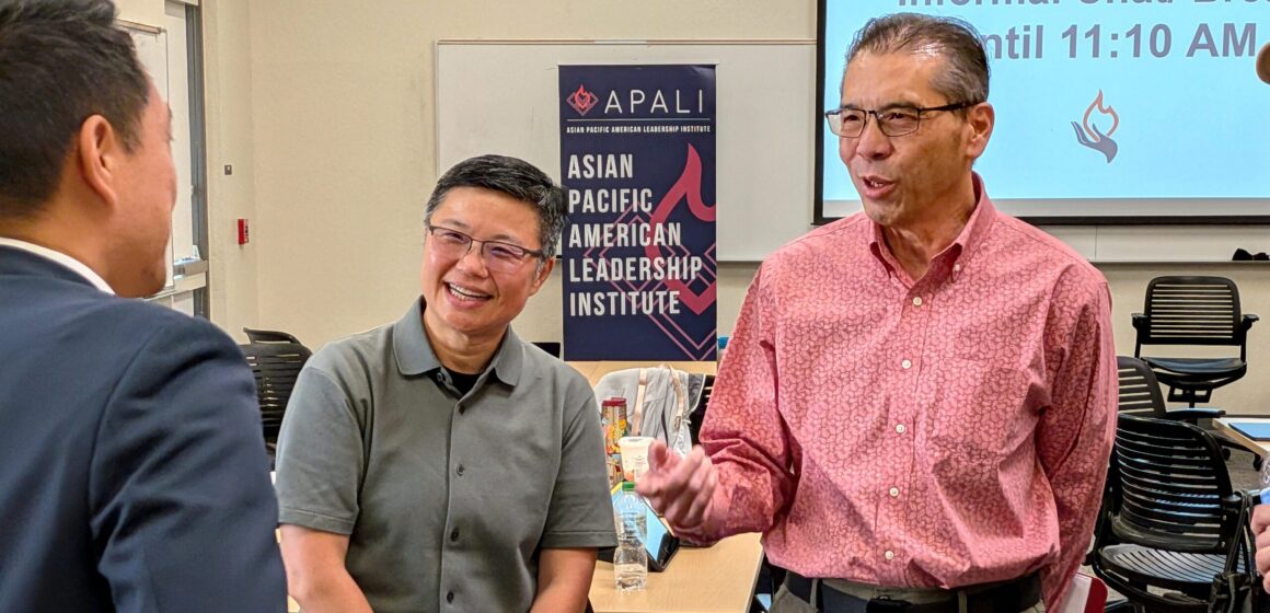 Three Asian men speaking at an event in Santa Clara, California
