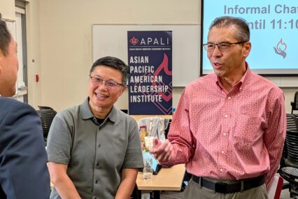 Three Asian men speaking at an event in Santa Clara, California