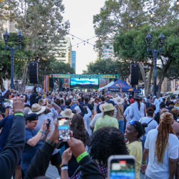 A crowd of people watching an outdoor music performance in San Jose, California