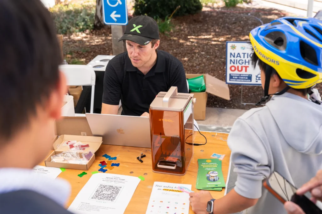 A person sitting at a table with a laptop and 3D printer in Mountain View, California