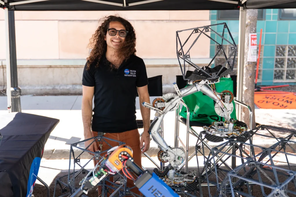 A person standing next to a robotics experiment in Mountain View, California