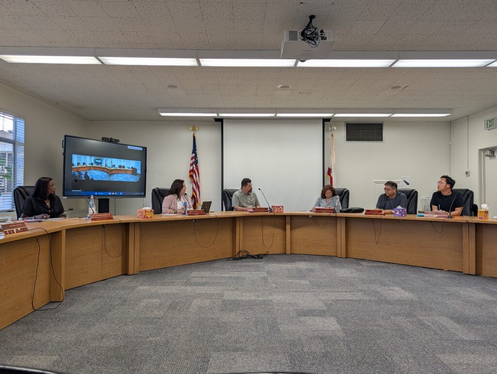 People sitting at a dais at a school board meeting in San Jose, California