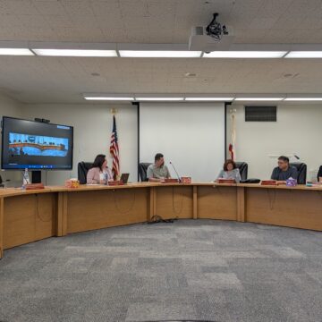 People sitting at a dais at a school board meeting in San Jose, California