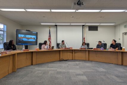 People sitting at a dais at a school board meeting in San Jose, California