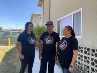 South Bay Community Land Trust The Virginian Apartments San Jose Three people standing in front of an apartment complex in San Jose, California