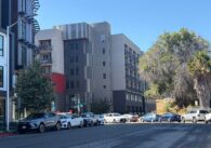 Cars parked on a street outside an apartment building in Santa Clara, California