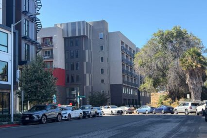 Cars parked on a street outside an apartment building in Santa Clara, California