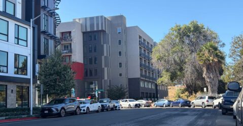Cars parked on a street outside an apartment building in Santa Clara, California