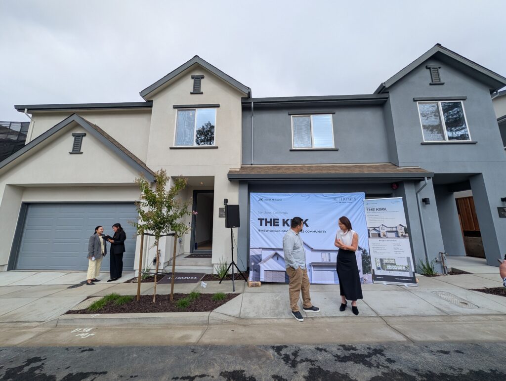 People standing in front of townhomes in East San Jose, California