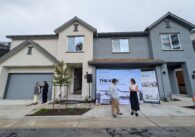 People standing in front of townhomes in East San Jose, California
