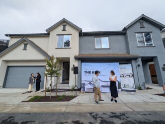 THE KIRK People standing in front of townhomes in East San Jose, California