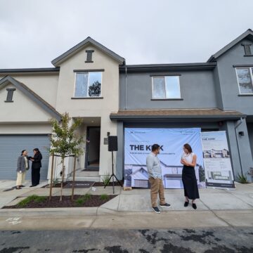 THE KIRK People standing in front of townhomes in East San Jose, California