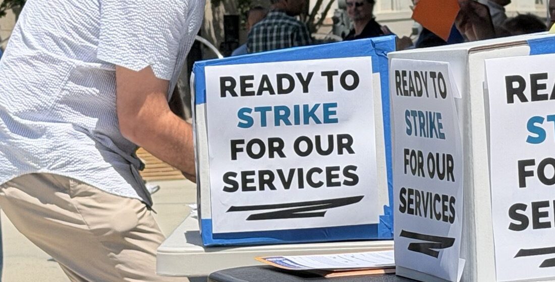 Public workers strike vote A man votes behind a cardboard barrier.