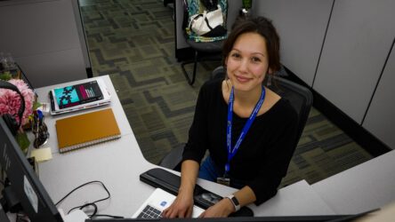 A woman sitting at a desk with a keyboard