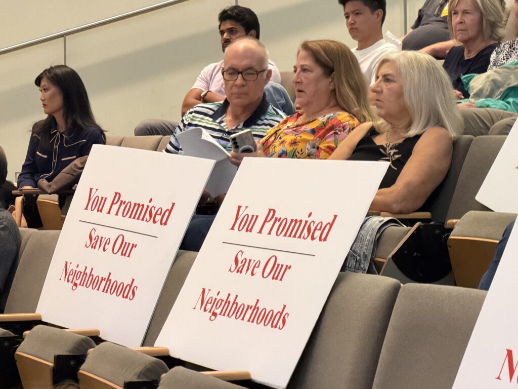 People sit in an auditorium.