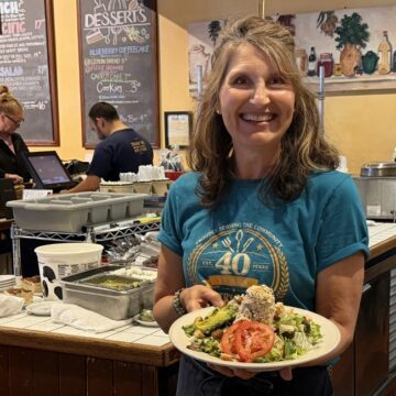 Country Gourmet A woman standing in a restaurant with a plate of food in Sunnyvale, California