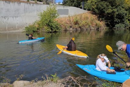 People in kayaks floating on a river in San Jose, California