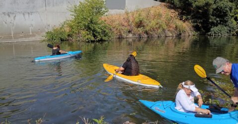 People in kayaks floating on a river in San Jose, California