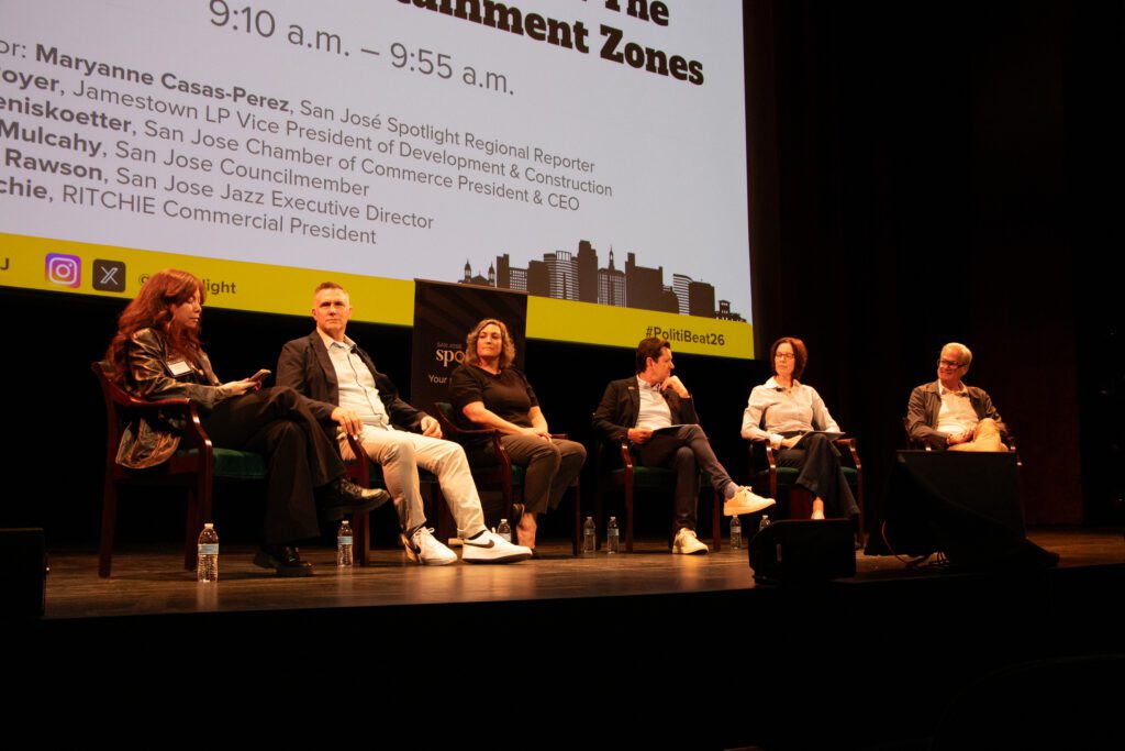 People sitting in chairs on a stage
