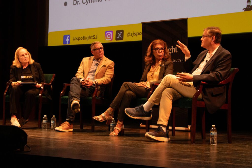 People sitting in chairs on a stage