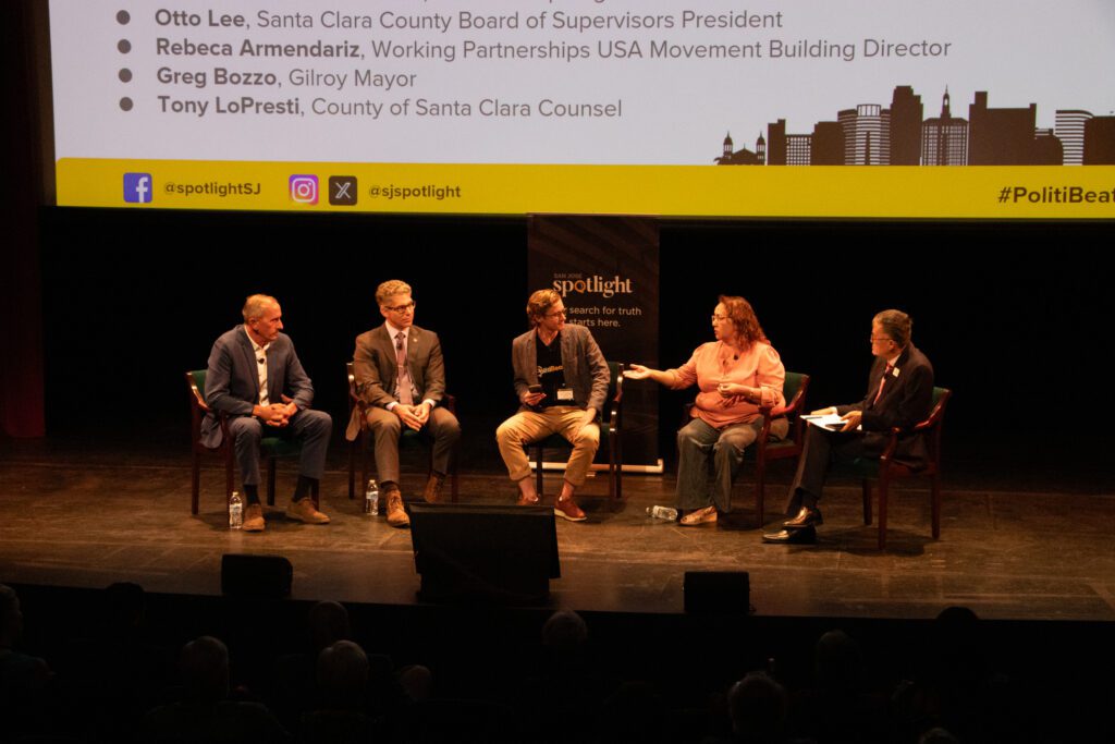 People sitting in chairs on a stage