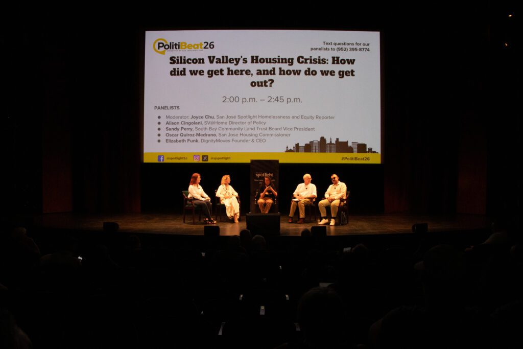 People sitting in chairs on a stage