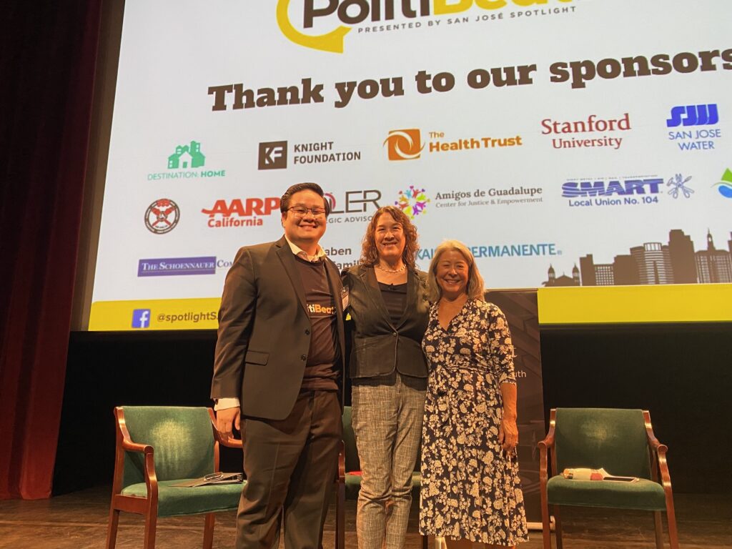 Three people standing on a stage