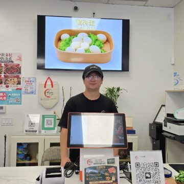 One Step Market Owner (Yaodong Guo) A man behind a counter at a market in San Jose, California