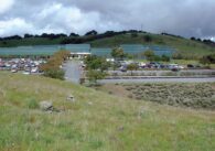 A grass hil in front of a parking lot in San Jose, California