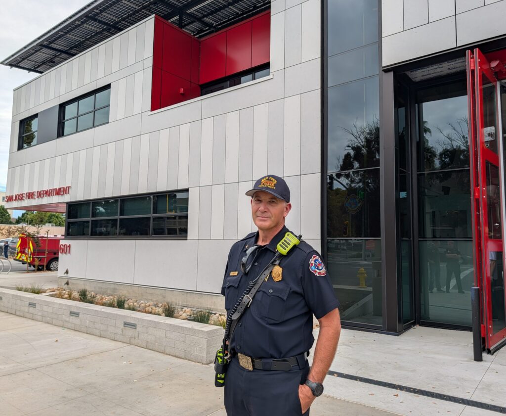 A firefighter standing in front of a new fire station in San Jose, California