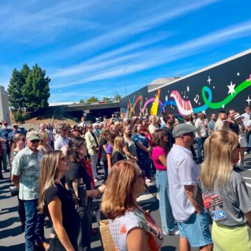 A crowd of people at a ribbon cutting in San Jose, California