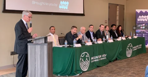 A group of people sitting at a long table at a candidate forum in Mountain View, California