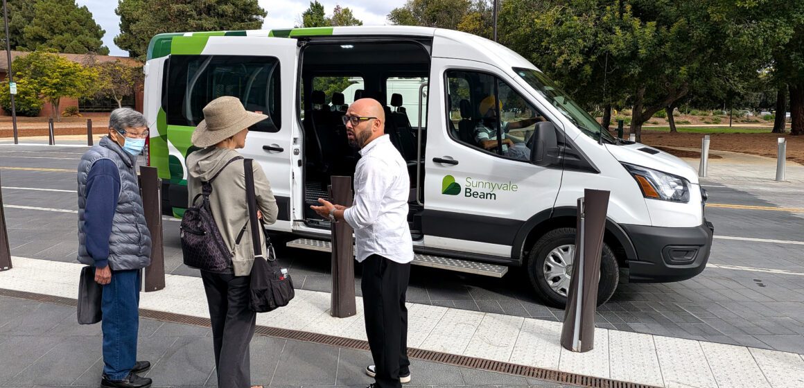 Sunnyvale Beam - Residents People standing in front of a ride-hailing vehicle in Sunnyvale, California