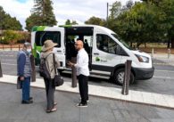 People standing in front of a ride-hailing vehicle in Sunnyvale, California