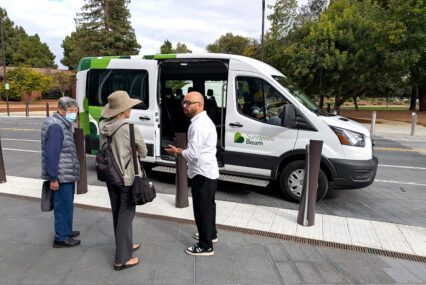 People standing in front of a ride-hailing vehicle in Sunnyvale, California