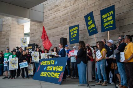 People's Tech Coalition launch A group of people with signs rallying in front of city hall in San Jose, California