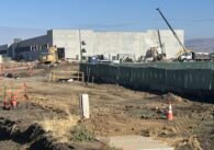 Amazon data center construction sight in Gilroy with construction trucks and a crane.